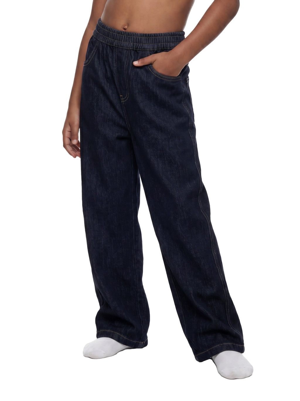 A person wearing dark indigo denim lounge pants with an elastic waistband and side pockets, paired with white socks, shown against a plain white background.