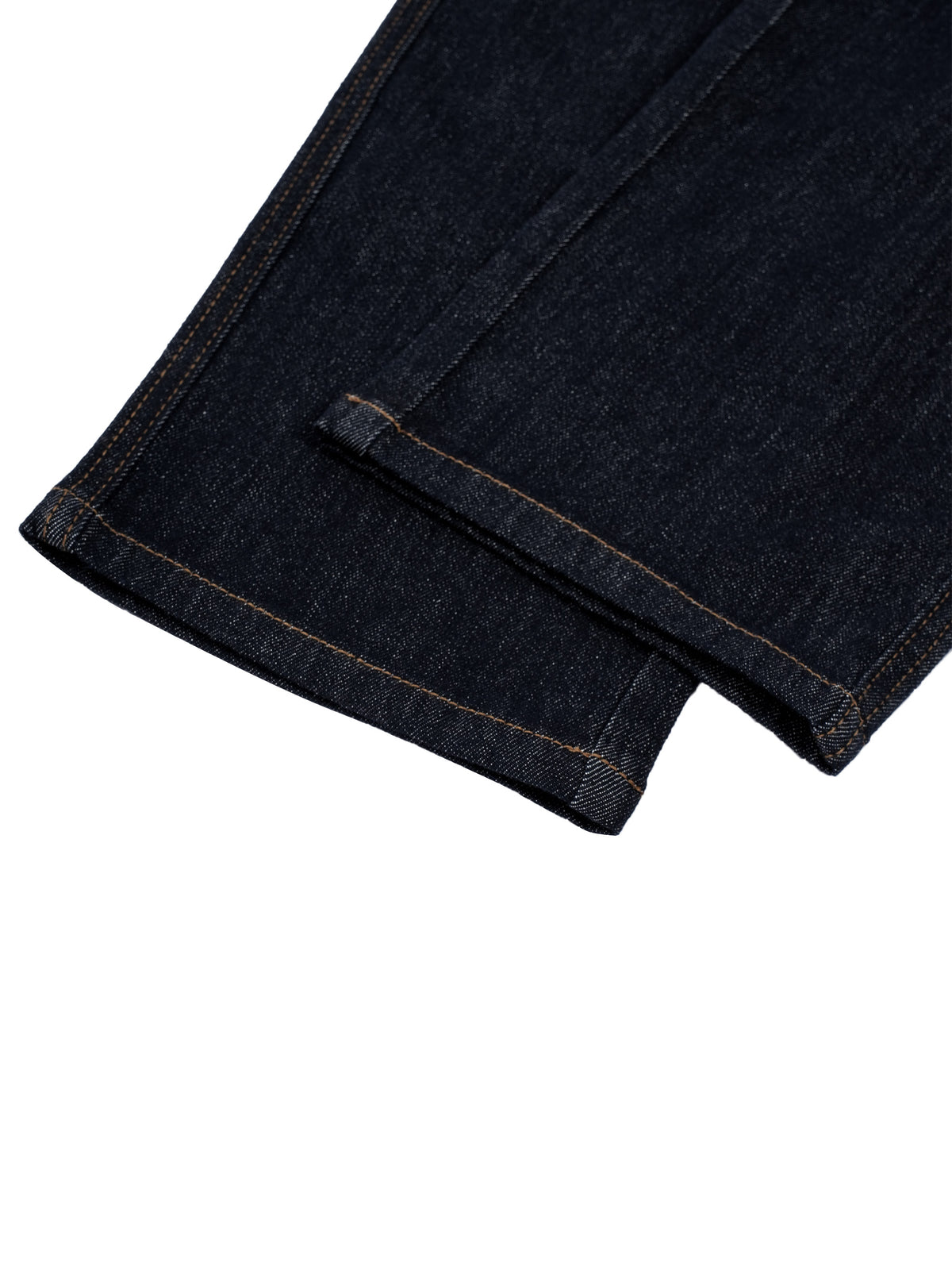Close-up of a dark indigo denim fabric cuff with contrast tan stitching, folded over on a plain white background.
