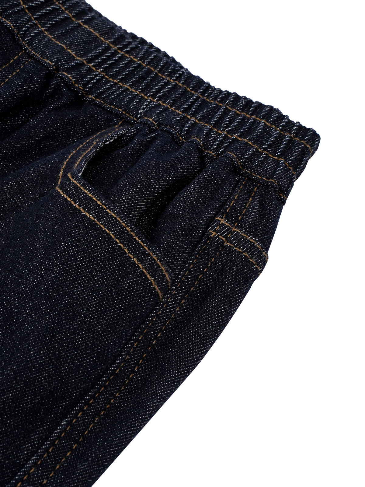 Close-up detail of dark indigo denim jeans showing the elastic waistband and pocket stitching on a white background.
