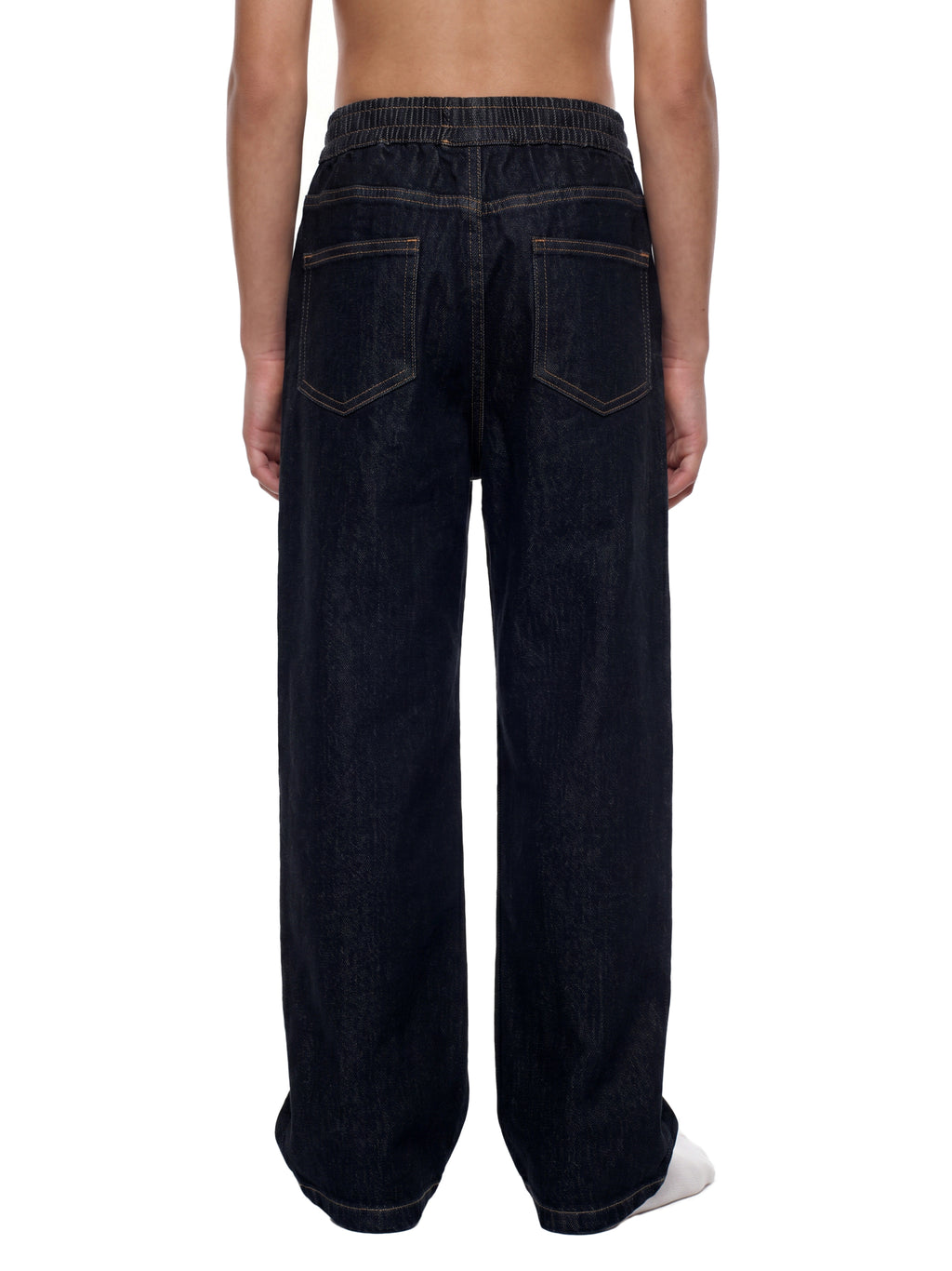 Rear view of a person wearing dark indigo wide-leg jeans with contrast stitching and an elastic waistband, shown against a plain white background.