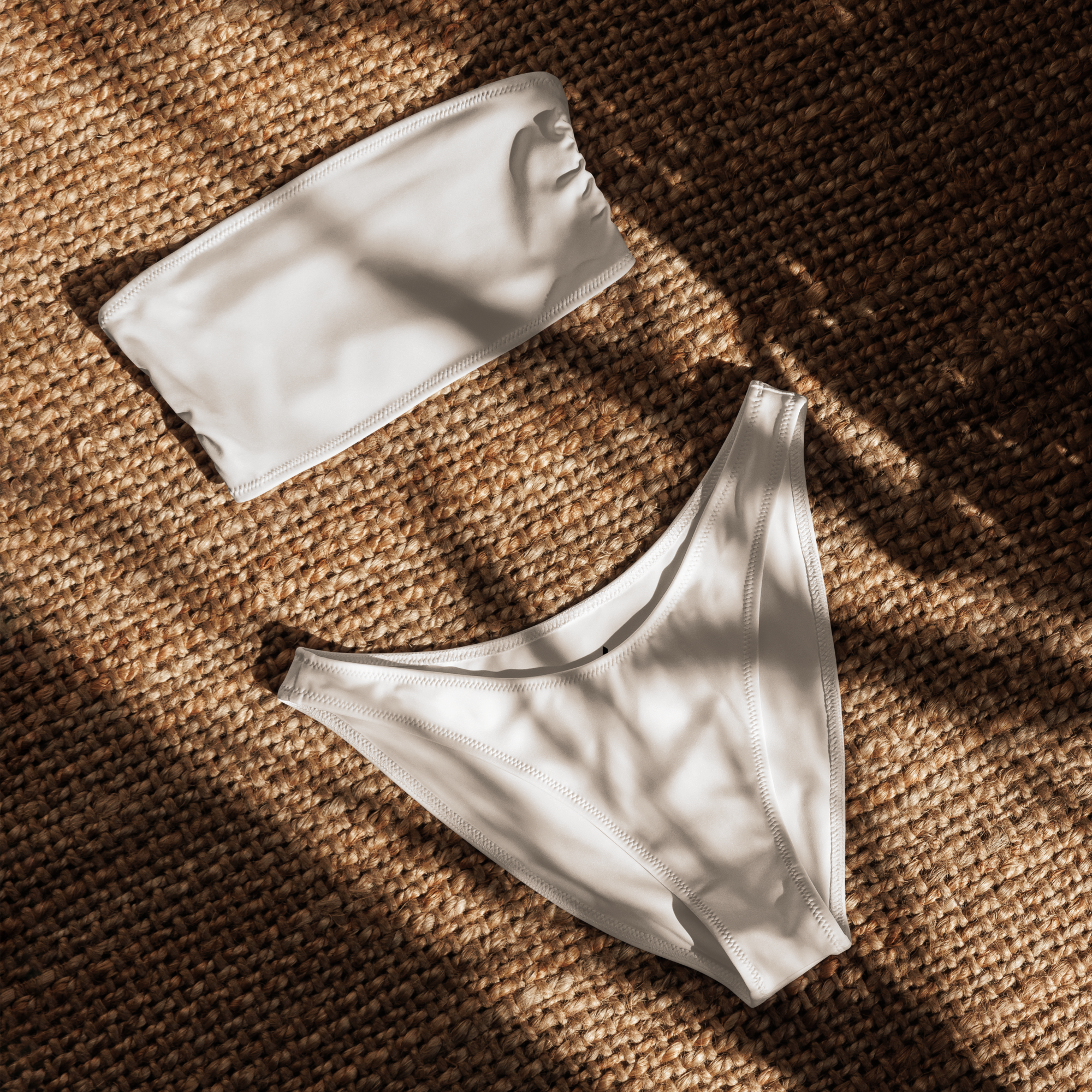 photoshoot_white bikini top and bottom on a textured brown surface